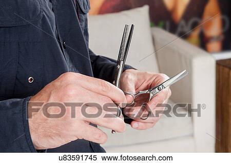 Hairdresser holding scissors View Large Photo Image Stock Photography - Hairdresser holding scissors. Fotosearch