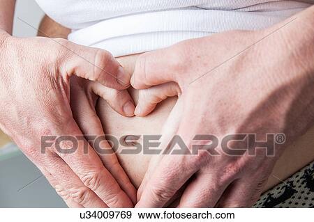 Hands and belly View Large Photo Image Stock Photo - Hands and belly. Fotosearch