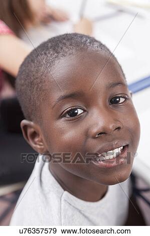 Happy african boy looking at camera and smiling View Large Photo Image Stock Photo - Happy african boy looking at camera and smiling. Fotosearch