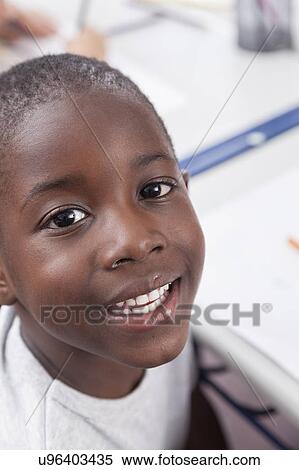 Happy african boy looking at camera and smiling View Large Photo Image Stock Photography - Happy african boy looking at camera and smiling. Fotosearch