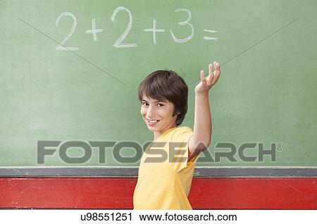 Stock Image - Happy boy at school and looking at camera. Fotosearch