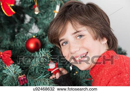 Happy boy beside the christmas tree View Large Photo Image Stock Image - Happy boy beside the christmas tree. Fotosearch