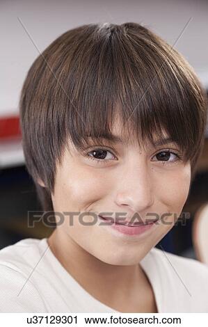 Stock Image - Happy boy looking at camera. Fotosearch