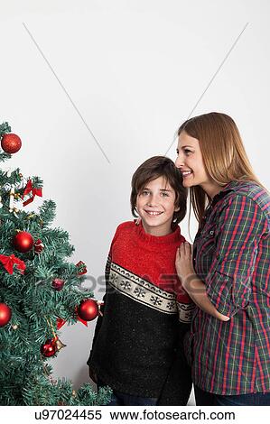 Happy boy looking to the camerabeside the christmas tree View Large Photo Image Stock Photography - Happy boy looking to the camerabeside the christmas tree. Fotosearch