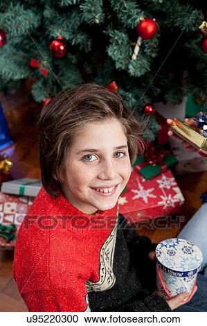 Happy boy opening the christmas gifts View Large Photo Image Stock Image - Happy boy opening the christmas gifts. Fotosearch