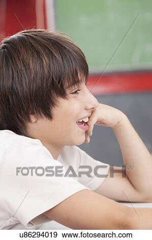 Stock Photo - Happy boy smiling in school. Fotosearch
