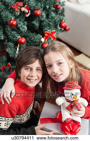 Stock Image - Happy brothers in christmas. Fotosearch