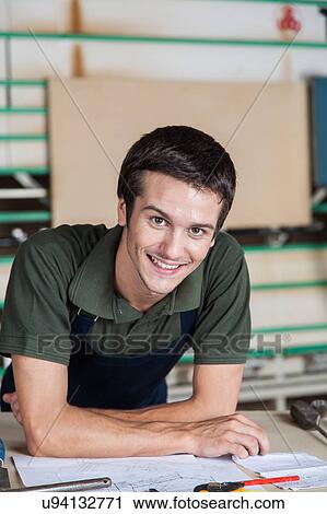Happy carpenter in his desk View Large Photo Image Stock Image - Happy carpenter in his desk. Fotosearch