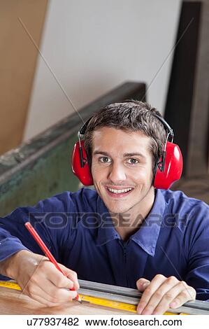 Happy carpenter in his workshop View Large Photo Image Stock Image - Happy carpenter in his workshop. Fotosearch