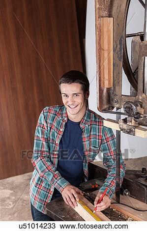 Happy carpenter measuring View Large Photo Image Stock Image - Happy carpenter measuring. Fotosearch