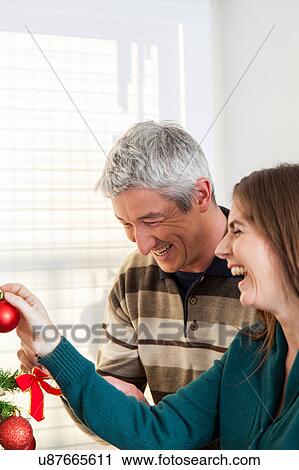 Stock Image - Happy couple decorating. Fotosearch
