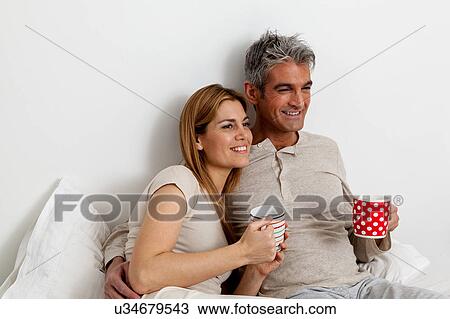 Happy couple drinking tea in the bed View Large Photo Image Stock Image - Happy couple drinking tea in the bed. Fotosearch