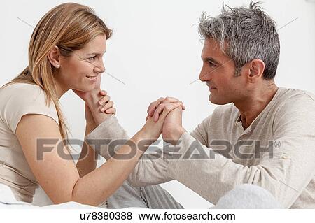 Stock Photo - Happy couple having fun in the bed. Fotosearch