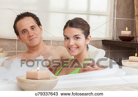 Stock Image - Happy couple in the tub of spa. Fotosearch