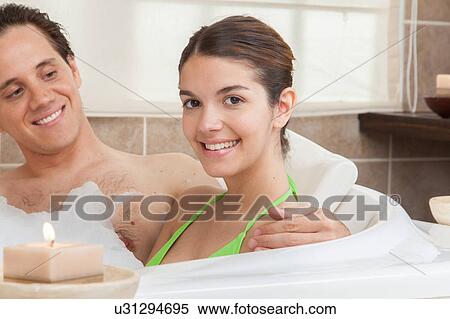 Stock Photography - Happy couple in the tub of spa. Fotosearch