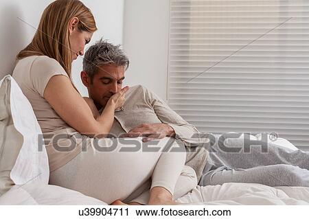 Happy couple lying in the bed View Large Photo Image Stock Image - Happy couple lying in the bed. Fotosearch