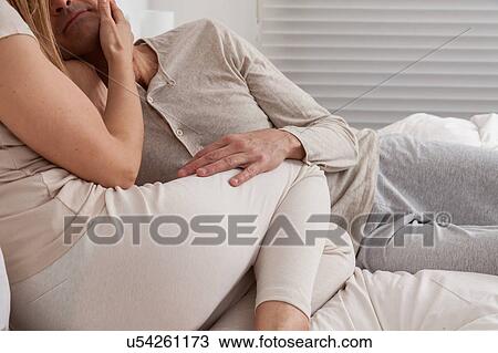 Happy couple lying in the bed View Large Photo Image Stock Image - Happy couple lying in the bed. Fotosearch