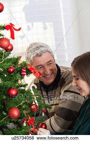 Stock Photo - Happy couple on christmas eve. Fotosearch