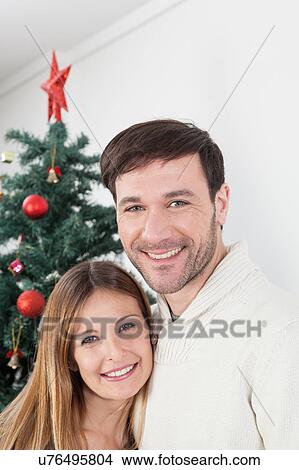 Picture - Happy couple smiling in christmas. Fotosearch