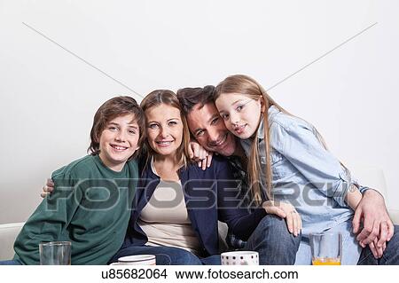 Picture - Happy couple with your childrens sitting . Fotosearch