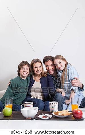 Happy couple with your childrens sitting View Large Photo Image Stock Photo - Happy couple with your childrens sitting . Fotosearch