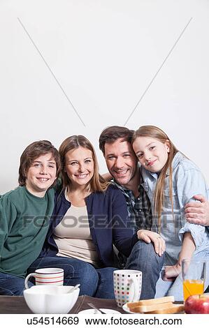 Happy couple with your childrens sitting View Large Photo Image Stock Photo - Happy couple with your childrens sitting . Fotosearch