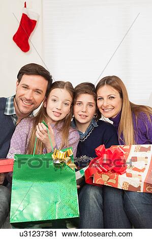 Stock Image - Happy family celebrating the christmas. Fotosearch