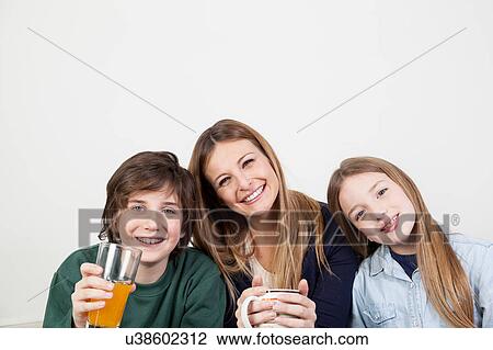 Happy family drinking juice together View Large Photo Image Stock Image - Happy family drinking juice together. Fotosearch