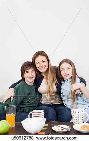 Happy family having the breakfast together View Large Photo Image Stock Photo - Happy family having the breakfast together. Fotosearch