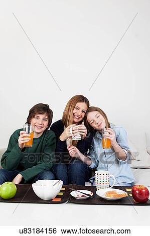 Happy family having the breakfast View Large Photo Image Stock Photograph - Happy family having the breakfast. Fotosearch