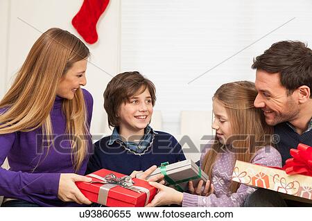 Happy family opening the christmas gift View Large Photo Image Stock Photography - Happy family opening the christmas gift. Fotosearch
