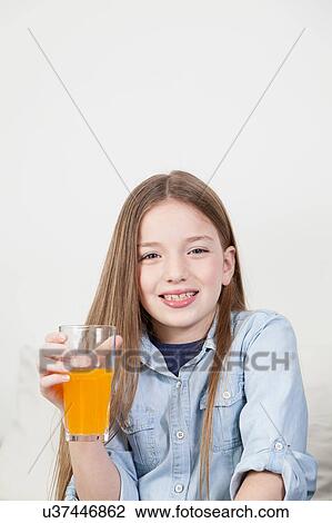 Happy girl drinking a juice View Large Photo Image Stock Image - Happy girl drinking a juice. Fotosearch