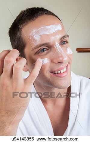 Happy guy putting face cream with your finger View Large Photo Image Stock Photograph - Happy guy putting face cream with your finger. Fotosearch