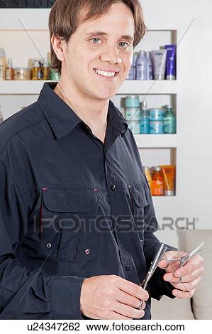 Happy hairdresser holding scissors View Large Photo Image Stock Image - Happy hairdresser holding scissors. Fotosearch