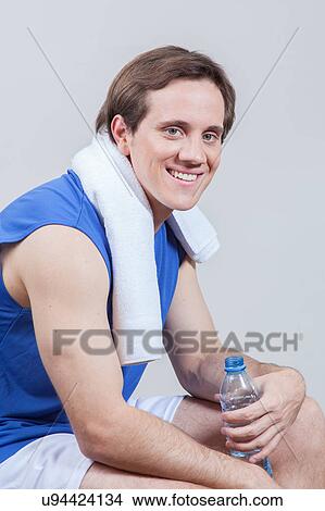 Happy man holding a bottle of water View Large Photo Image Picture - Happy man holding a bottle of water. Fotosearch