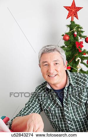 Picture - Happy man in christmas. Fotosearch