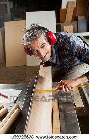 Happy man in his workshop View Large Photo Image Stock Photo - Happy man in his workshop. Fotosearch