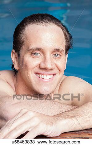 Stock Photo - Happy man resting in the edge of the pool. Fotosearch