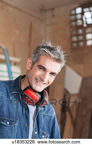 Stock Photograph - Happy man with protector hearing. Fotosearch