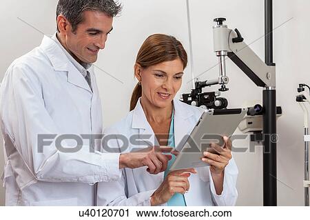 Happy ophthalmologists discussion View Large Photo Image Stock Image - Happy ophthalmologists discussion. Fotosearch