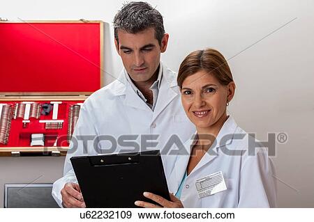 happy ophthalmologists looking at chart View Large Photo Image Stock Photo - happy ophthalmologists looking at chart. Fotosearch