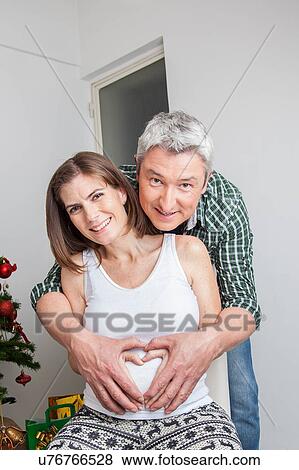 Stock Photo - Happy pregnant wife and husband. Fotosearch