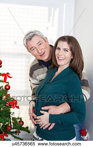 Stock Photography - Happy pregnant woman in christmas. Fotosearch