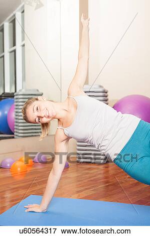 Stock Photo - Happy woman making yoga. Fotosearch