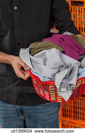 Holding laundry basket View Large Photo Image Picture - Holding laundry basket. Fotosearch