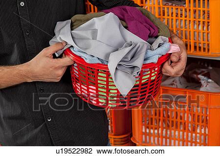 Stock Image - Holding laundry basket. Fotosearch