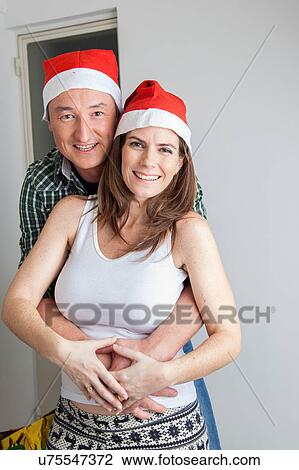 Stock Image - Husband hands on the belly of his pregnant wife. Fotosearch