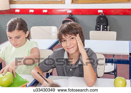 Stock Photo - little boy studying. Fotosearch