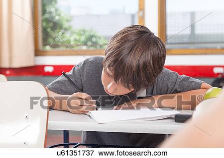 Stock Photo - little boy studying. Fotosearch