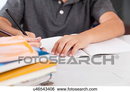 Stock Photograph - little boy studying. Fotosearch